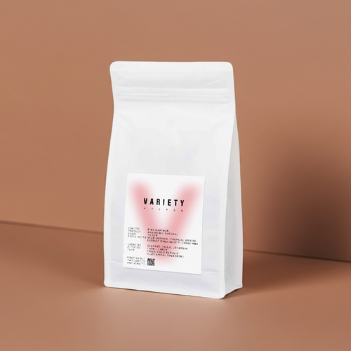 A white stand-up pouch of coffee or tea variety seeds, standing on a warm brown surface against a matching brown background. The front label reads 'VARIETY Coffee' with small text below.